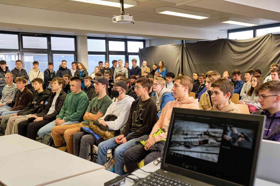 Studieninteressierte hören sich einen Vortrag an.